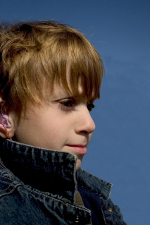 Boy wearing a hearing aid.