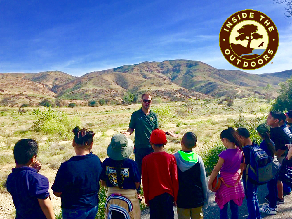 Naturalist teaching students in foothill mountains